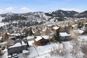 View of mountain backdrop featuring nearby suburban area
