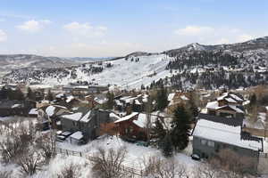 Snowy aerial view with a mountain view and a residential view