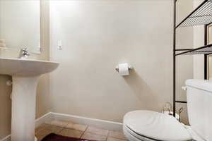 Bathroom with baseboards and light tile patterned floors