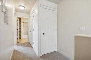 Hallway with light colored carpet