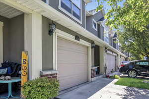 View of home's exterior featuring stucco siding, an attached garage, and concrete driveway