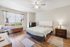 Bedroom featuring wood finished floors and a ceiling fan