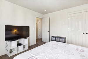 Bedroom featuring dark carpet and a closet