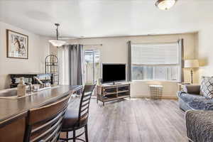 Living area featuring wood-type flooring and baseboards