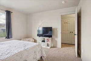 Bedroom with light carpet and baseboards