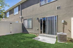 Rear view of property with stucco siding, a gate, and entry steps