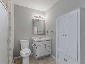 Bathroom featuring vanity, a shower stall, light tile patterned floors, and a textured ceiling