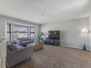 Living area with carpet flooring and baseboards
