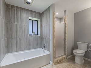 Full bath featuring a shower stall and a bath