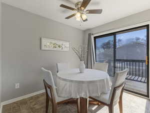 Dining space with baseboards and a ceiling fan
