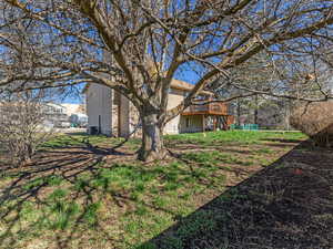 Back of house with a deck