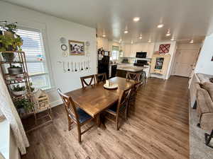 Dining room featuring dark wood-style flooring and recessed lighting