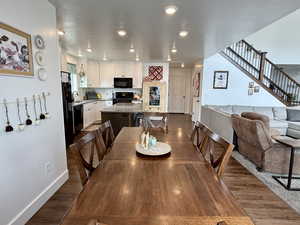 Dining space featuring dark wood-style floors and recessed lighting