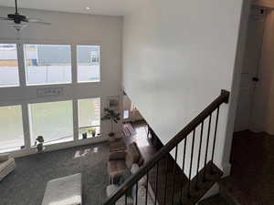 Staircase with carpet flooring, a high ceiling, recessed lighting, and a ceiling fan