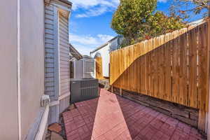 Fenced backyard with a patio area and a shed