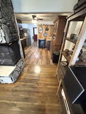 Living room with dark wood-style floors and a ceiling fan