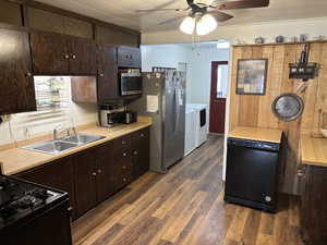 Kitchen featuring dark wood finish cabinets, black dishwasher, light countertops, and a ceiling fan