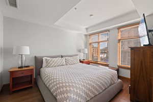 Bedroom featuring hardwood / wood-style flooring and baseboards