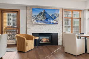 Living area with wood finished floors and a fireplace