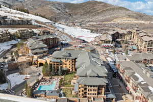 Snowy aerial view featuring a mountain view