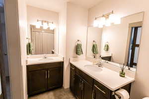 Full bath with vanity and a shower with curtain