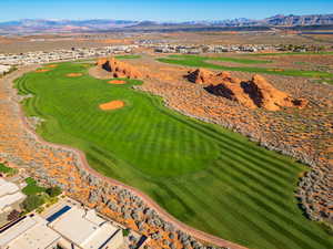 Drone / aerial view of a mountain backdrop and a golf course