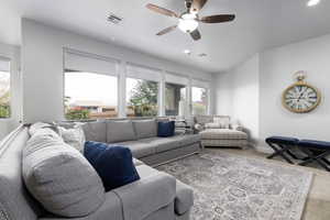 Living room featuring carpet floors, ceiling fan, and recessed lighting