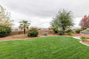Fenced backyard with a hot tub
