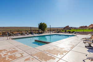 Community pool with a patio and a mountain view