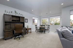Family room with light colored carpet and recessed lighting