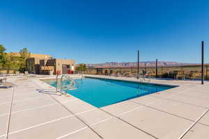Community pool featuring a patio and a mountain view