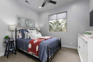Bedroom 2 featuring light colored carpet, ceiling fan, and recessed lighting