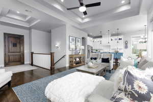 Living room featuring recessed lighting, wood finished floors, ceiling fan, and arched walkways