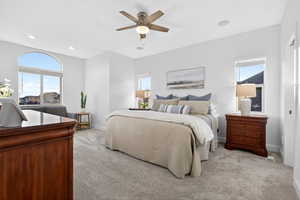 Bedroom with light colored carpet and ceiling fan
