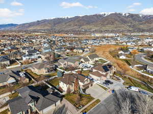 Aerial overview of property's location featuring a mountainous background and nearby suburban area