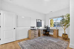 Office with light wood finished floors and baseboards