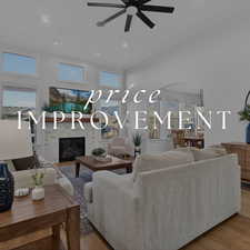 Living area with a brick fireplace, arched walkways, a ceiling fan, wood finished floors, and recessed lighting