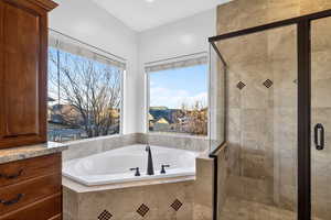Bathroom with a stall shower and a garden tub