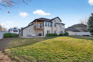 Back of property featuring a balcony, a patio area, stucco siding, and outdoor seating