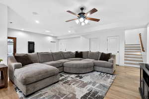 Living room featuring ceiling fan, light wood-style flooring, and recessed lighting
