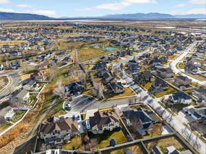 Aerial overview of property's location with nearby suburban area and mountains