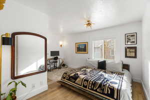 Bedroom with baseboards and light wood-style flooring