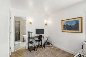 Home office featuring baseboards and light wood-type flooring
