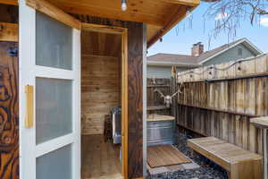 Sauna / steam room with wood walls and hardwood / wood-style flooring