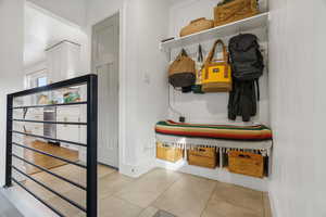 Mudroom featuring baseboards and light tile patterned floors