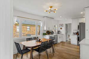 Dining room featuring light wood-style floors and a chandelier
