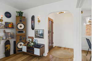 Hallway featuring light wood finished floors and baseboards
