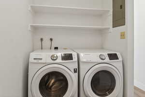 Laundry area with electric panel and washing machine and dryer