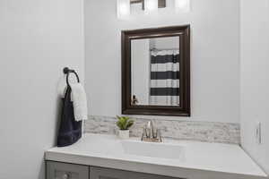 Bathroom with vanity and curtained shower