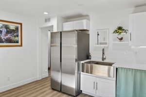 Basement Kitchen featuring freestanding refrigerator, white cabinetry, light wood-type flooring, open shelves, and recessed lighting